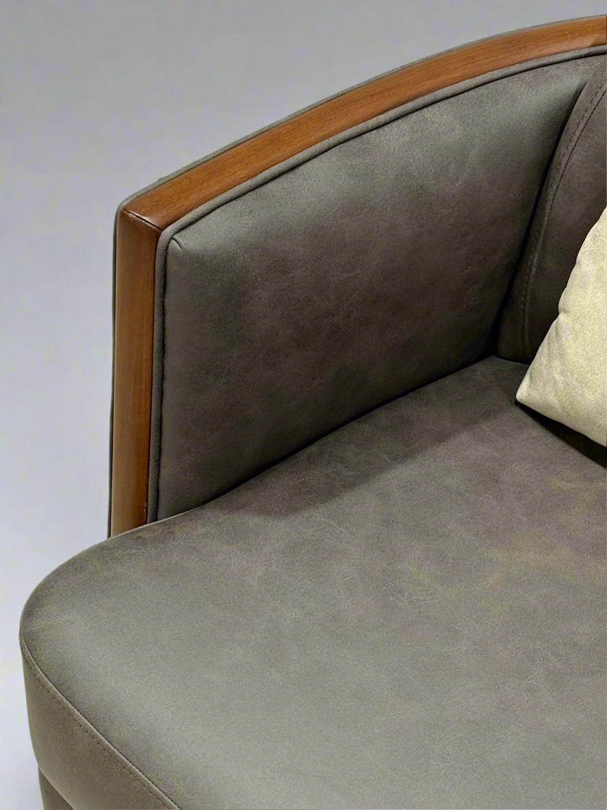 Gray sofa with wooden armrests on a light-colored rug